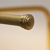 Close-up of antique brass rod with textured end, reminiscent of Harrow Picture Light 400mm.