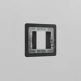 1G 25mm bronze brass module plate for switches, elegantly mounted on a white wall.
