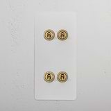 4G Vertical Two Way Toggle Switch in Paintable Antique Brass on a white rectangular panel against a white wall.