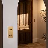 4G Vertical Two Way Toggle Switch in Antique Brass, part of the 4G Switches & Dimmers collection, on a wall.