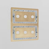 6G Switch Plate in antique brass mounted on a white wall, designed for brass switch integration.