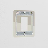 Polished Nickel 1G Rocker Switch Plate made of brass, complements white wall without confusion.