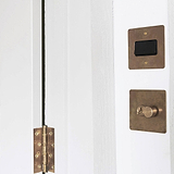 Antique brass black fan isolator switch on white wall, perfect for controlling fans with classic style.