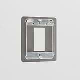 Bronze 1G Rocker Switch Plate in brass finish, mounted on a light-colored wall for a sleek modern look.