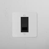 Paintable Black BT Master Socket on white wall plate; 1G socket, blendable with decor, mounted on textured wall.