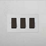 3G Two Way Rocker Switch in Paintable Bronze Black on white wall plate, for flexible décor customization.