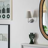Malvern Small Wall Light in Alabaster White with Polished Nickel finish, mounted on a wall.