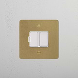 Antique Brass White Switched Fused Spur (FCU) Isolator Switch on a white wall, blending elegance and functionality.
