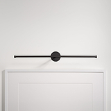 Bronze Taylor Picture Light 580mm, wall-mounted above a white frame on a white wall.