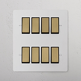 8G Two Way Rocker Switch panel in paintable antique brass black, featuring eight switches in two neat rows.