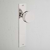 Onslow Long Plate Fixed Door Knob in polished nickel with a rectangular backplate on a white door.