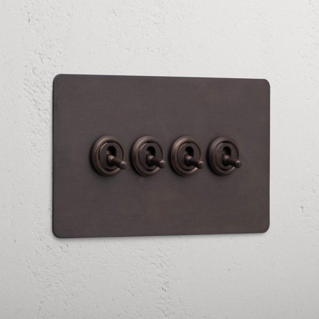 Bronze wall plate with four retractive toggle switches, '4G Toggle Retractive - Bronze'.