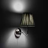 Medium Malvern Wall light in Deep Green at an angle and turned on at night