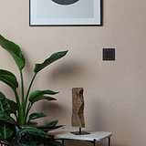 Bronze Black 2G Two Way Rocker Switch against a wall; part of 2G Switches & Dimmers collection.