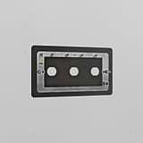 Bronze 3G brass switch plate on a white wall, designed for three switches.