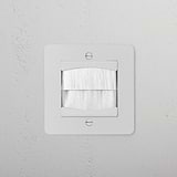 Paintable white single brush plate from 1G Sockets & Modules, designed for a clean cable entry.