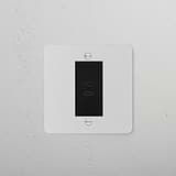 Paintable black 1G socket with USB C+C ports for versatile charging and connectivity.