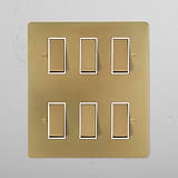 6G Two Way Rocker Switch in antique brass on a white plate, featuring six rectangular controls.
