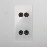 Clear bronze 4G vertical two-way toggle switch on a sleek white wall, enhancing modern functionality and design.