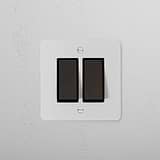 2G Two Way Rocker Switch, Paintable Bronze Black finish on white wall; sleek and stylish for seamless integration.