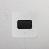 Paintable Black Fan Isolator Switch on white wall.