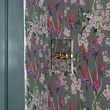 Clear Antique Brass 2G Two Way Toggle Switch set against floral wallpaper with green, white, and purple flowers.