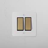 Paintable antique brass black 2G two way rocker switch on a white wall, part of 2G Switches & Dimmers.