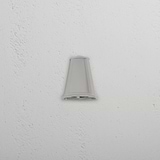 Southwark Mast Light – Polished Nickel small wall light, mounted on a white textured wall.