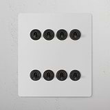 8G Two Way Toggle Switch in paintable bronze, includes eight black switches on a panel for 8G Switches & Dimmers.