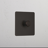 Bronze 1G digital dimmer switch with textured black square knob for controlling light intensity.