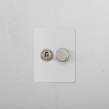 Polished Nickel 2G Mixed Slimline Switch 1T1D, paintable surface, shown on a white textured wall.