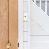 Close-up of a 1G architrave two-way toggle switch in clear antique brass finish on a wall.