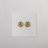 2G Two Way Toggle Switch - Paintable Antique Brass on a white textured wall. Suitable for 2G Switches & Dimmers.
