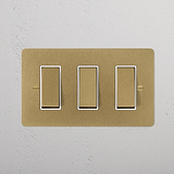 3G Two Way Rocker Switch in Antique Brass White on a white textured wall, part of the 3G Switches & Dimmers collection.