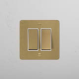 Antique brass 2G two-way rocker switch with white plate on textured wall, part of 2G switches & dimmers range.