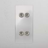 4G Vertical Toggle Switch in Clear Polished Nickel on a white plate at a pristine wall.