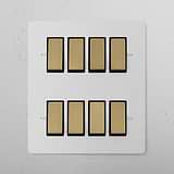 8G Two Way Rocker Switch panel in paintable antique brass black, featuring eight switches in two neat rows.