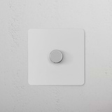 1G Two Way Dimmer Switch in paintable polished nickel on a textured white wall.