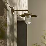 Kensington Wall Light Fluted Glass in antique brass, medium wall light with ribbed glass shade on beige wall.