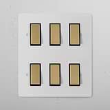 6G Two Way Rocker Switch in Paintable Antique Brass Black finish on a white panel, suitable for lighting control.