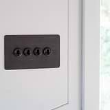 Bronze 4G two way toggle switch fixed to white wall
