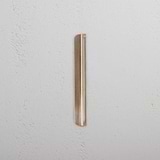 Oxford Furniture Handle 128mm in Antique Brass, small pull handle against a textured white wall.