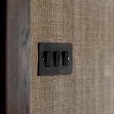 Bronze Black 3G Two Way Rocker Switches on a brown textured wall, adding elegance to the setting.