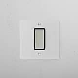 1G Centre Retractive Rocker Switch in paintable polished nickel black on a white wall, ideal for minimalist decor.