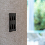 6G Two Way Rocker Switch in Bronze Black finish on a textured wall, ideal for 6G switches and dimmers.