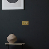 Antique Brass White 3G Two Way Rocker Switch on a dark wall; part of the 3G Switches & Dimmers range.