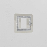 Polished Nickel 1G 25mm Brass Module Plate on a wall, designed for style and functionality.