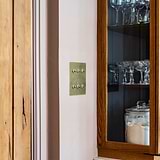 Antique brass 6G two-way toggle switch on beige wall, part of 6G Switches & Dimmers collection.