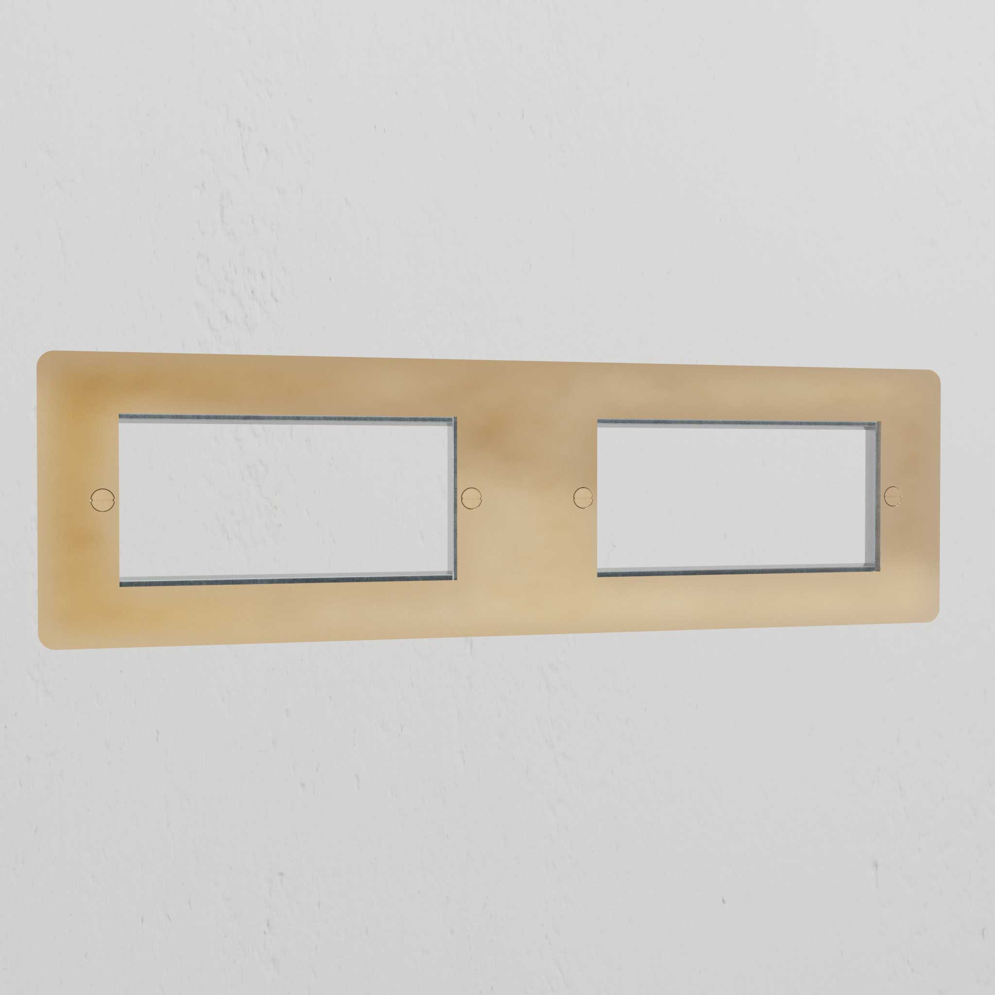 Antique Brass 4G 100mm Module Plate with four openings, showcasing a classic finish against a white wall.