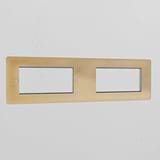 Antique Brass 4G 100mm Module Plate with four openings, showcasing a classic finish against a white wall.